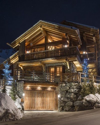 Cosy timber lodges lit by warm light, perfect for unforgettable winter getaways.
